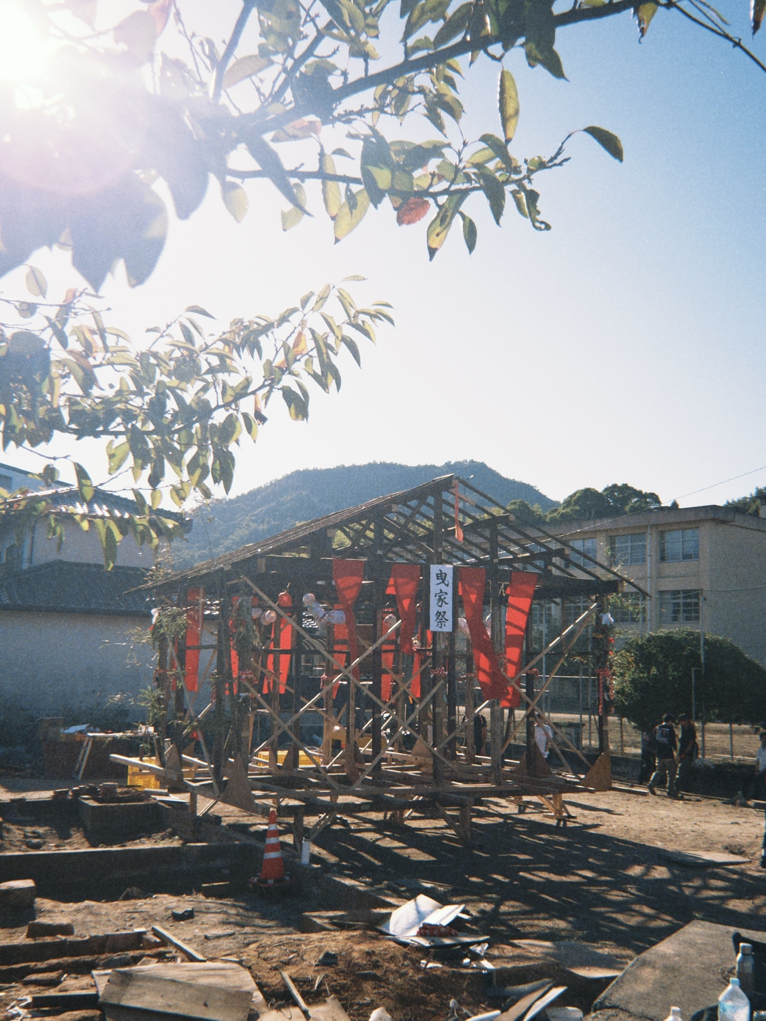Timber festival pavilion with red banners